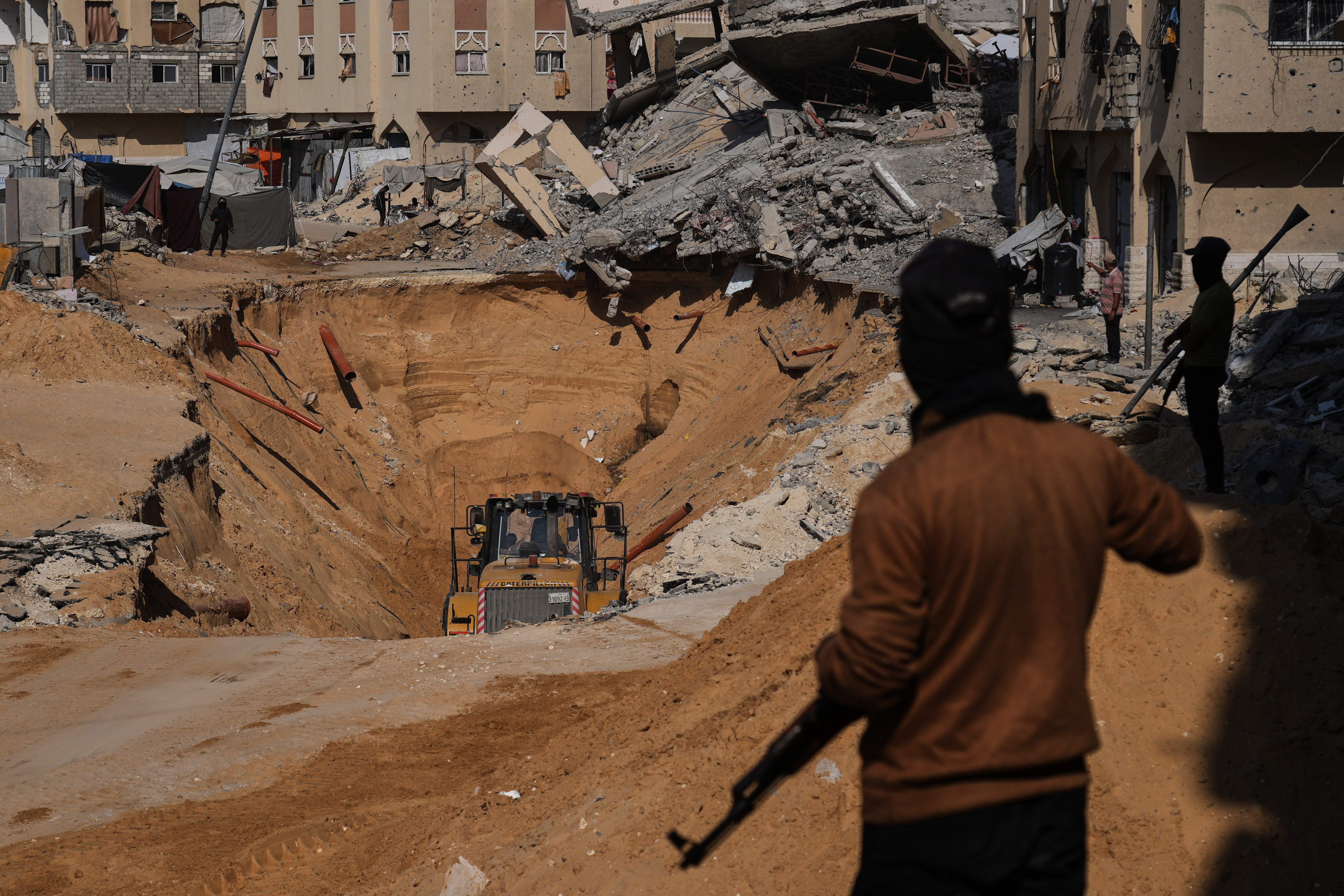 Hamas members search underground for the bodies of Israeli hostages in Khan Younis, in southern Gaza, on Sunday. Also on Sunday, Israel said it traded attacks with Hamas in the Rafah area, threatening the fragile ceasefire.